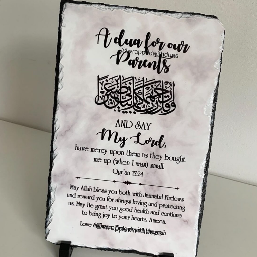 A rectangular slate plaque with a black rustic edge and printed Islamic calligraphy and text reading 'A dua for our Parents' and a prayer, shown standing against a light neutral background.