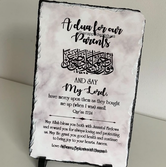 A rectangular slate plaque with a black rustic edge and printed Islamic calligraphy and text reading 'A dua for our Parents' and a prayer, shown standing against a light neutral background.