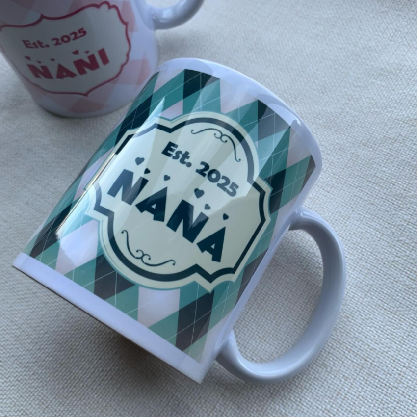 A white ceramic mug with an argyle pattern and a central cream-colored label that reads 'Est. 2025 NANA'